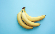 two bananas on a light blue background