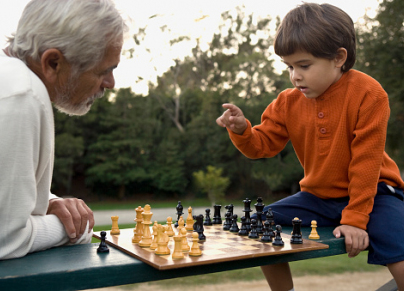 grandfather and grandson playing chess